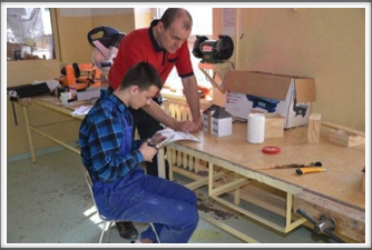 Teacher Tomasz supervises the cutting of veneers