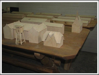 Close-up view of Oflag 64 building models in the carpentry shop